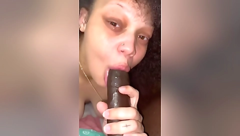 A brunette milf with a large black cock enjoys oral sex