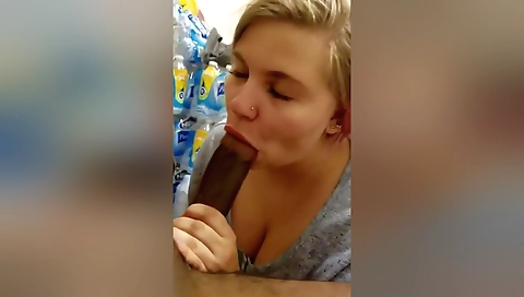 Blonde in a store room gives a deepthroat handjob to the guy