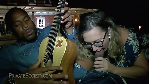 Busty milf with tattooed tits sucking big dick on the bed